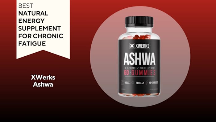 Clear pill bottle filled with red pills with a black label that says "ASHWA"